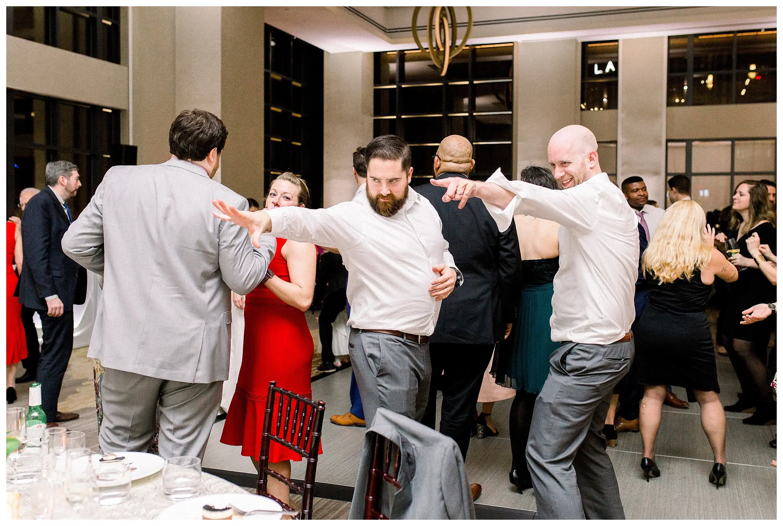 Wedding guests dancing together on a packed floor